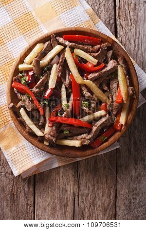 Peruvian Cuisine: Lomo Saltado On A Plate. Vertical Top View