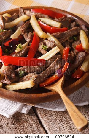 Peruvian Food: Lomo Saltado Close-up On A Plate. Vertical