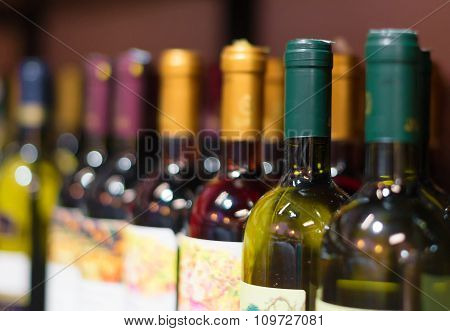 Wine bottles row in the wine store.
** Note: Shallow depth of field