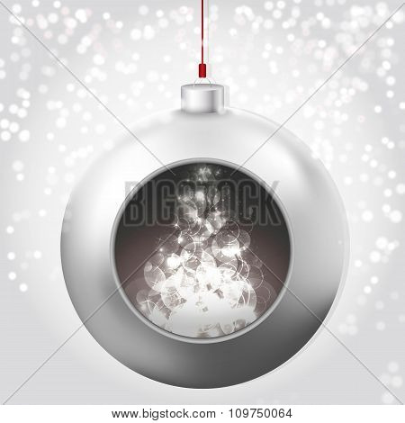 Christmas Ball with magic glow on the snowy background