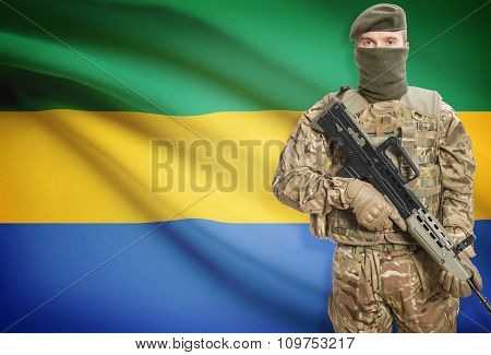 Soldier Holding Machine Gun With Flag On Background Series - Gabon