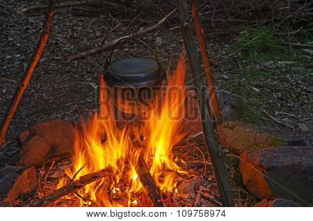 Cooking Dinner In Cauldron Pot Over An Open Fire
