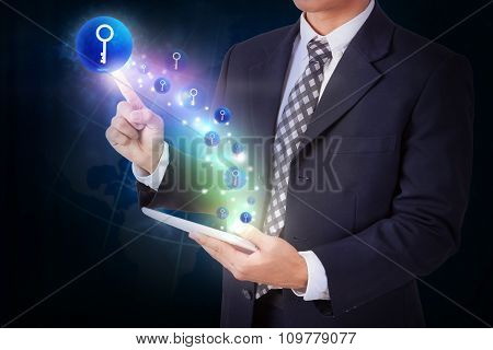 Businessman holding tablet with pressing key icon button. internet and networking concept