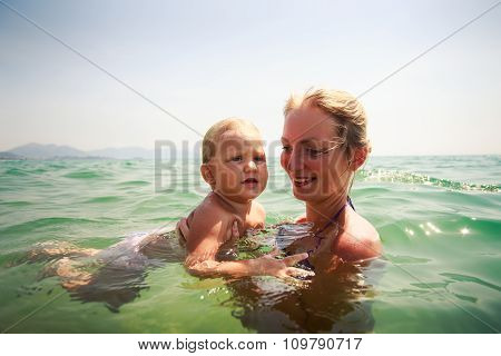 Mother Small Daughter Bathe In Transparent Azure Sea Smile