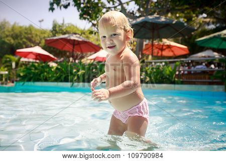Closeup Small Blonde Girl Smiles Plays In Shallow Swimming Pool