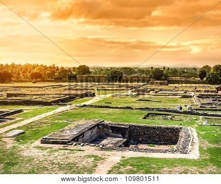 View of ancient stepwell from the platform of Mahanavami Dibba at sunset overcast sky in Hampi Karnataka India. Stepwells were developed to cope with seasonal fluctuations in water availability.