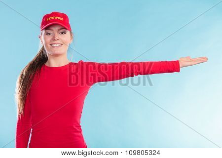 Happy Lifeguard Woman In Cap Pointing Direction.