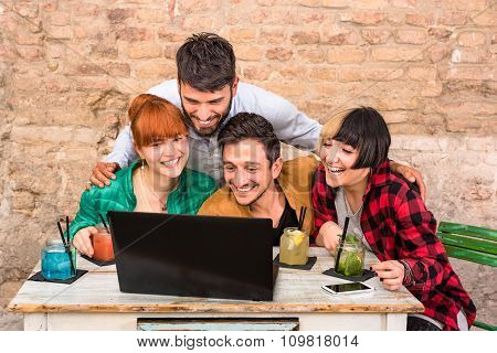 Group Of Young Hipster Best Friends With Computer In Urban Alternative Studio - Friendship Concept
