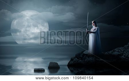 Elven girl on sea coast at night