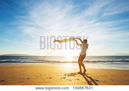 Happy Joyful Father and Son Playing on the Beach at Sunset. Fatherhood Family Concept