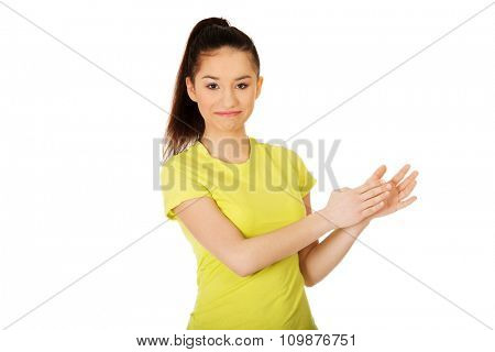 Happy teenager clapping her hands.