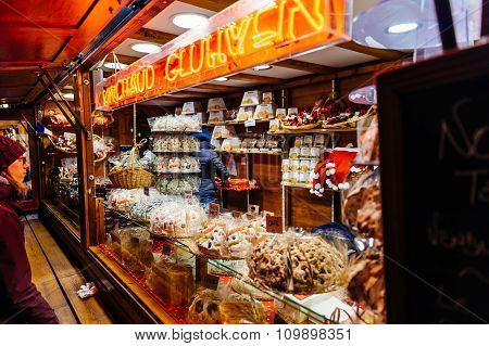 Christmas Market Stall With People Admiring Christmas Sweets