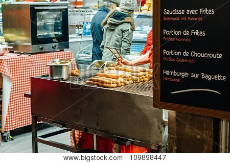 Christmas Market With People Preparing Traditional Alsatian Wurst