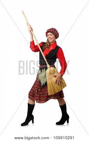 Funny woman in scottish clothing with broom