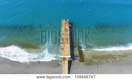 Many people swim in sea near pier with Turkish Flag at summer sunny day. Aerial view videoframe