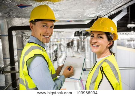 Engineers checking the temperature pipes in the control room