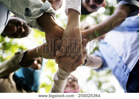 Group of diverse youth with teamwork joined hands