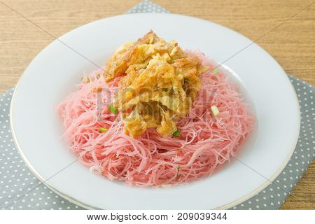 Thai Cuisine and Food Red Stir Fried Rice Noodle Served with Julienne Omelet and Chopped Scallion.
