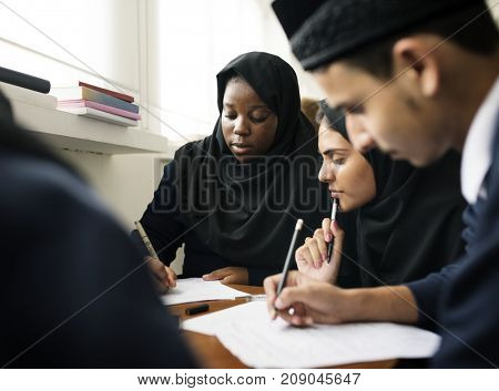 Diverse Muslim children studying in classroom