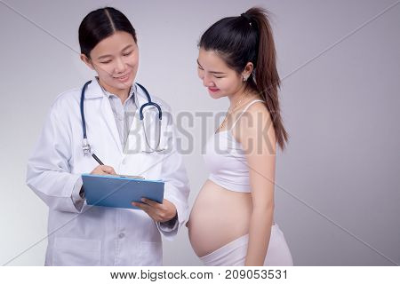 Pregnancy motherhood people medicine and fertility concept - happy pregnant woman with doctor at maternity hospital.