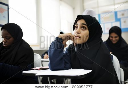 diverse muslim children studying in classroom