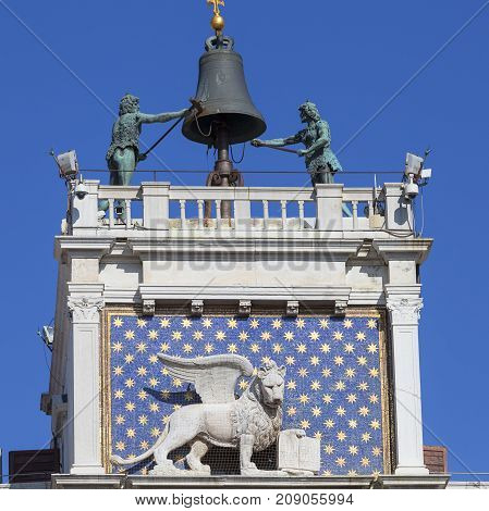 St Mark's Clock tower on Piazza San Marco Venice Italy. On the facade of the tower is the astronomical clock Lion of Saint Mark and Madonna with Child.At the top is a bell and Moors figures