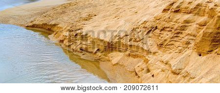 The River At The Foot Of The Sandy Cliff