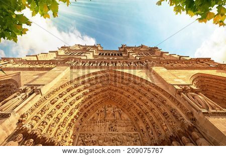 Notre-dame Cathedral In Paris France With Golden Light Rays.