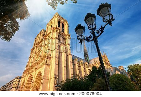 Notre-dame Cathedral In Paris France With Golden Light Rays.