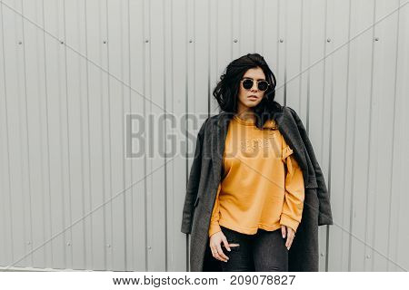 Portrait Of Stylish Modern Young Curly Woman In Coat Sunglasses