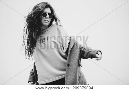 Portrait Of Stylish Modern Young Curly Woman In Coat Sunglasses