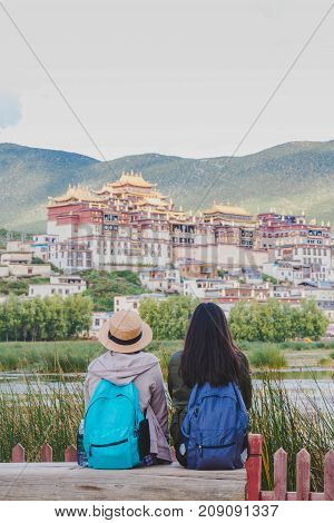 Female tourists are traveling in Little Potala Palace Lamasery The famous temple in shangri-la yunnan china