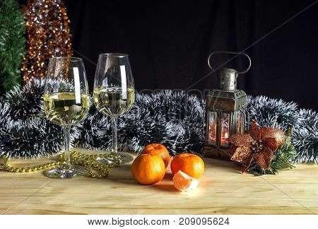 The Christmas and New Year still life with glasses of champagne on the table closeup