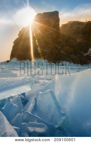 Field of blue ice and rocks Hoboy with sun. Russia. Lake Baikal