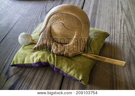 Kyoto, Japan - May 19, 2017: Traditional zen buddhist wooden fish gong, Mokugyo with a mallet on a pillow