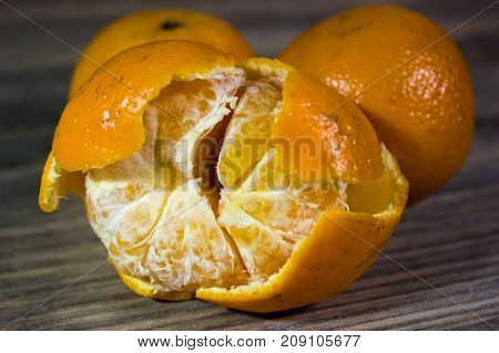 Mandarin slices on wooden tabke as background