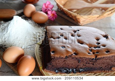 Taiwanese chocolate sponge cake with bambo mat on wooden board