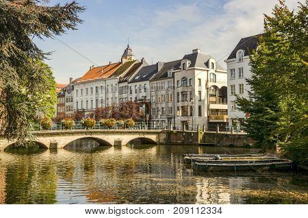 A view of the Belgian city, Lier and moored boats on the river Nete,