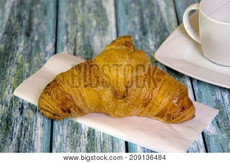 Traditional French butcher croissant on table. Typical european bakery - rogal francuski.