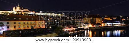 Prague, Czech Republic - October 10, 2017: Beautiful evening view on Dvorak embankment, Saint Vitus Cathedral, Vltava river and old town of Prague. Panorama of Prague city center, Czech Republic.