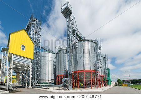 Modern large granary. Sunny day, blue sky, white clouds