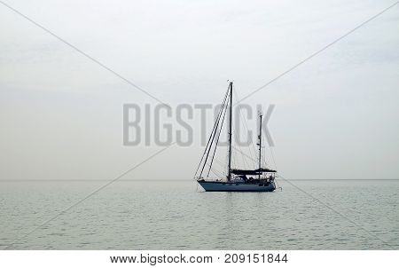 View on the sea with sailboat in a cloudy day. Location Canary Island Fuerteventura Spain.