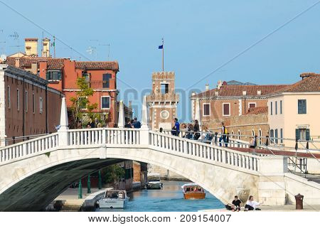 VENICE ITALY - SEPTEMBER 29 2017: Motorboats and bridge over a canal in the city of Venice Italy