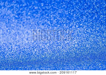 Some abstract defocused bright blue glitter background