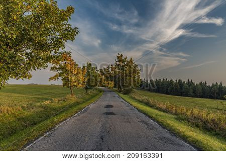 Color evening with road in Slavkovsky les national park in autumn time