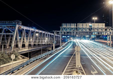 View of transport metropolis, traffic and blurry lights of cars on multi-lane highways and road junction at night in Moscow