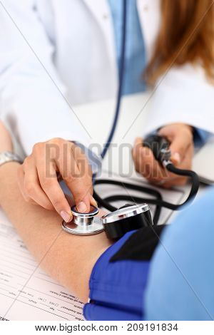 Female doctor arms make medic procedure closeup. Physical cure arterial beat exam tool nurse control and consult healthy lifestyle diagnosis therapeutist practice heal problem reception concept