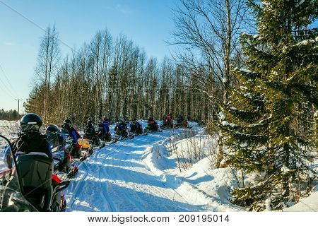  Finland. Winter fairy tale in a sunny frosty day. The first trip on snowmobiles. The concept of active and extreme tourism