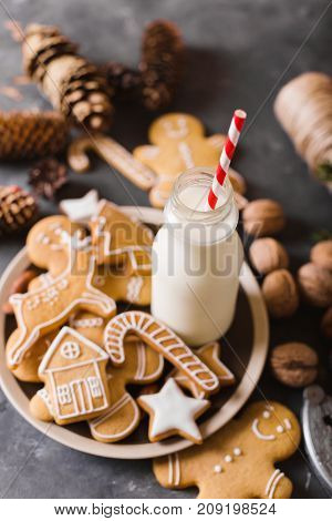 Milk and cookies. Gingerbread cookies on a gray background. Christmas cookies. Ginger men