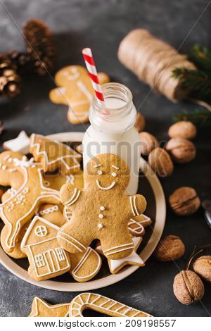 Milk and cookies. Gingerbread cookies on a gray background. Christmas cookies. Ginger men